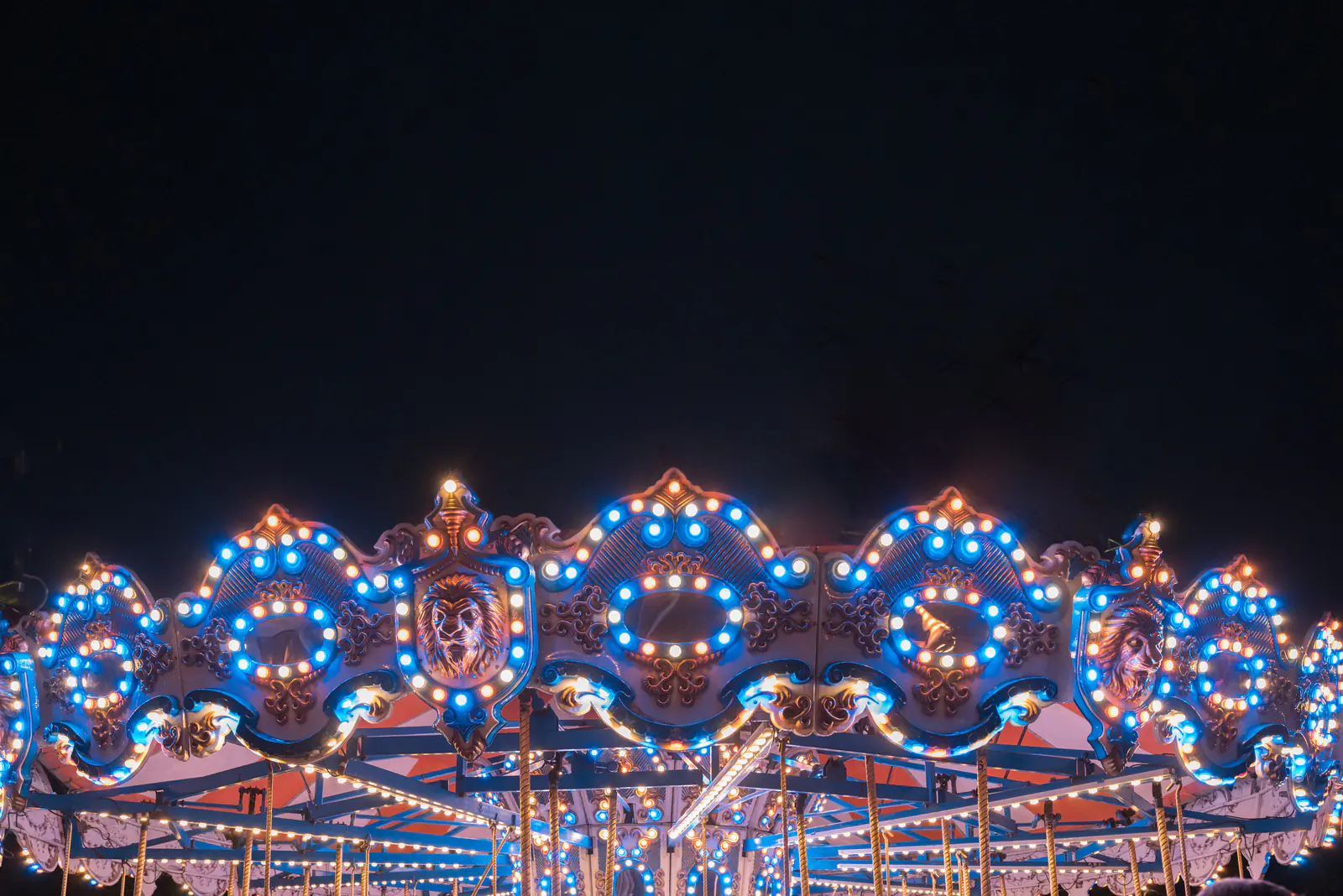 A carousel glowing with lights at night