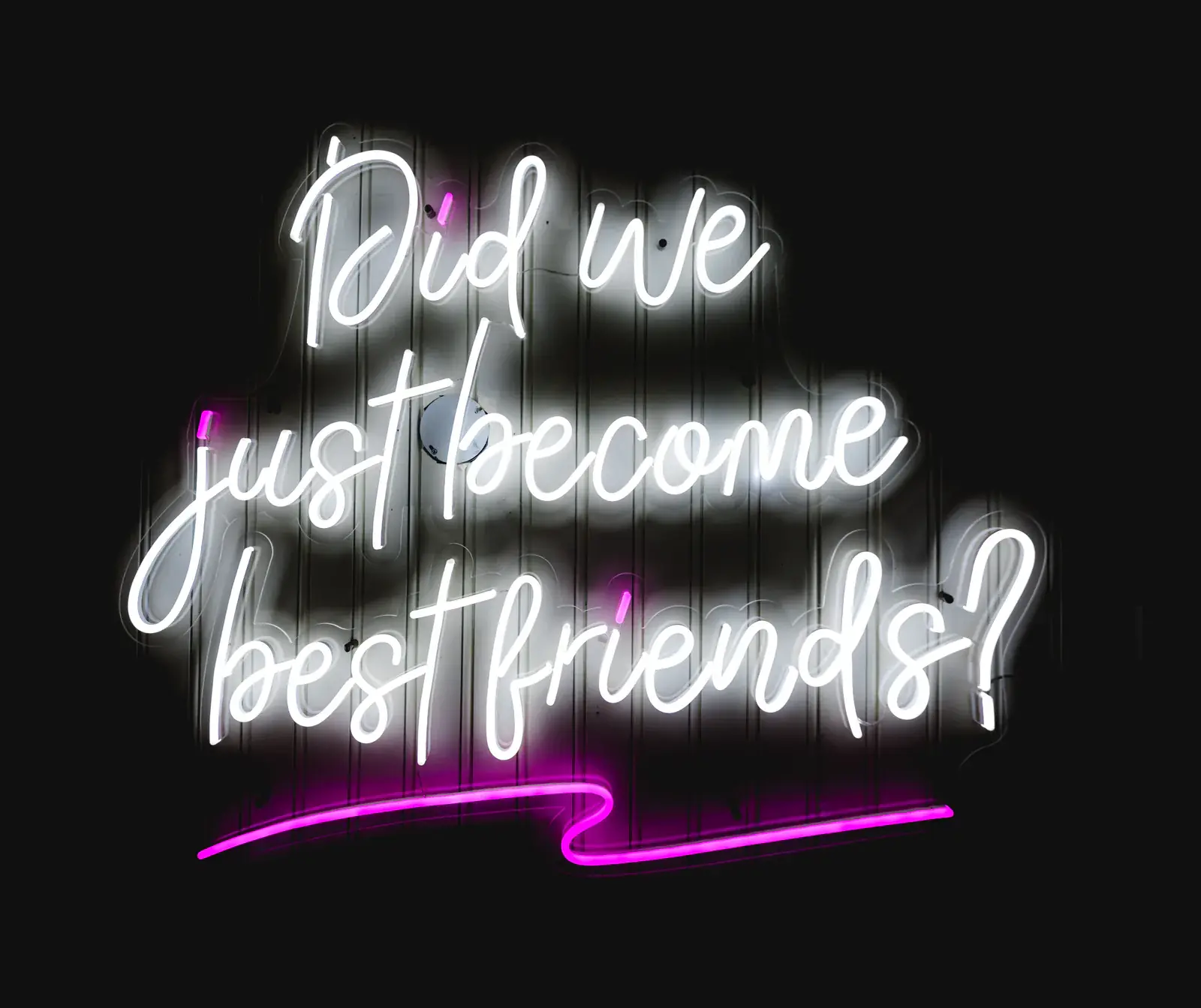 A neon sign reading "Did we just become best friends?"