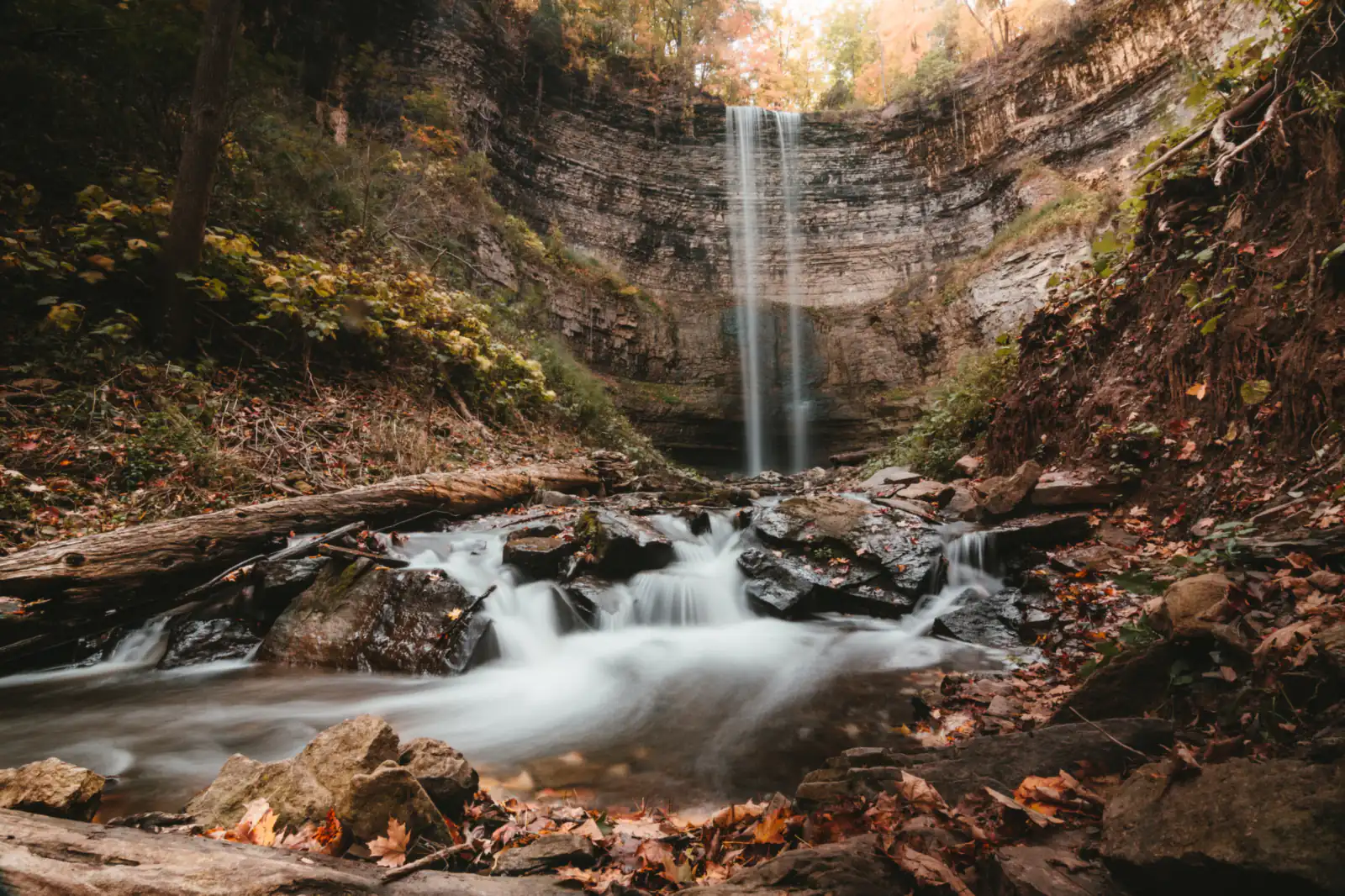 A waterfall in an autumn gorge