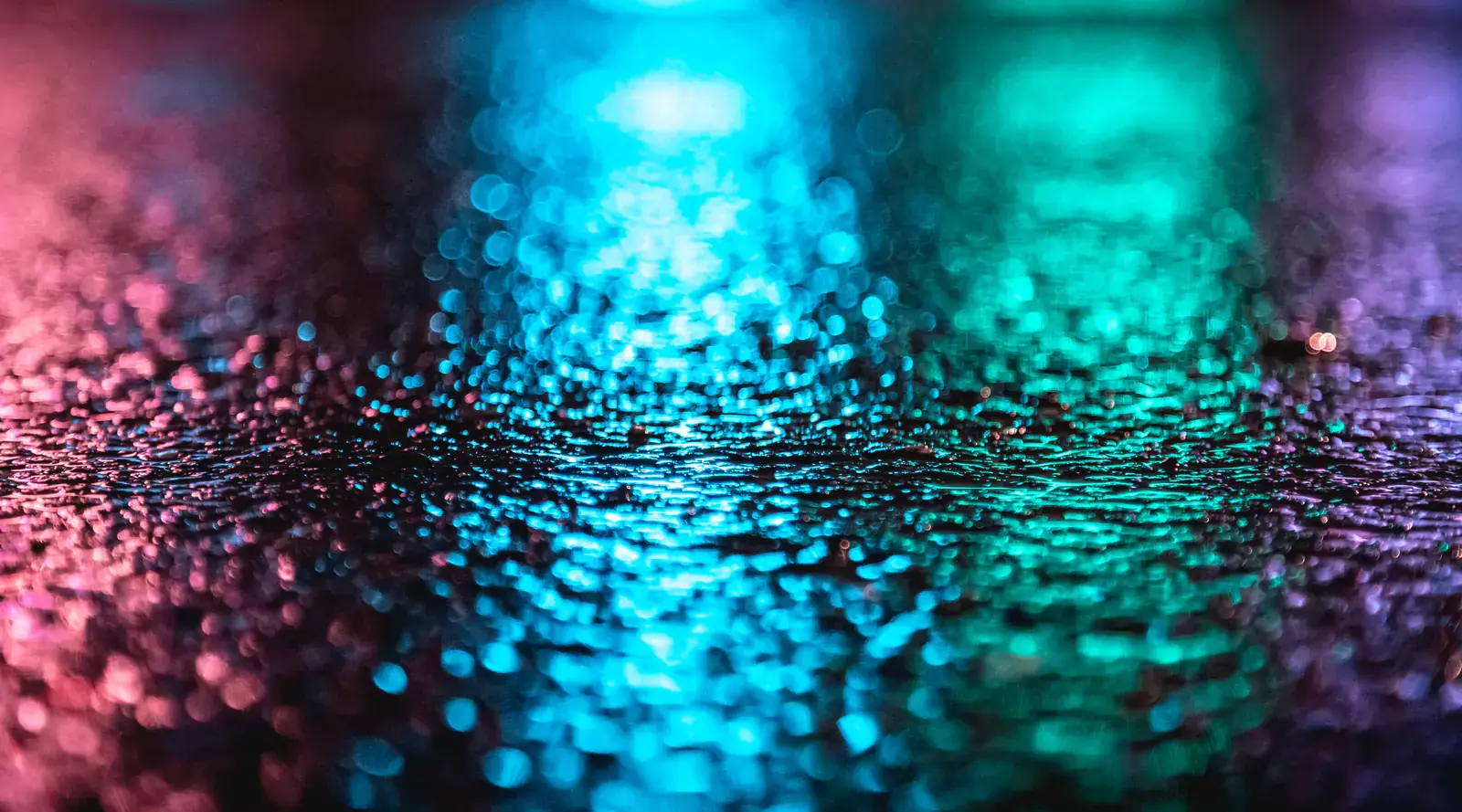 Pink, blue and teal city lights blurred into bokeh