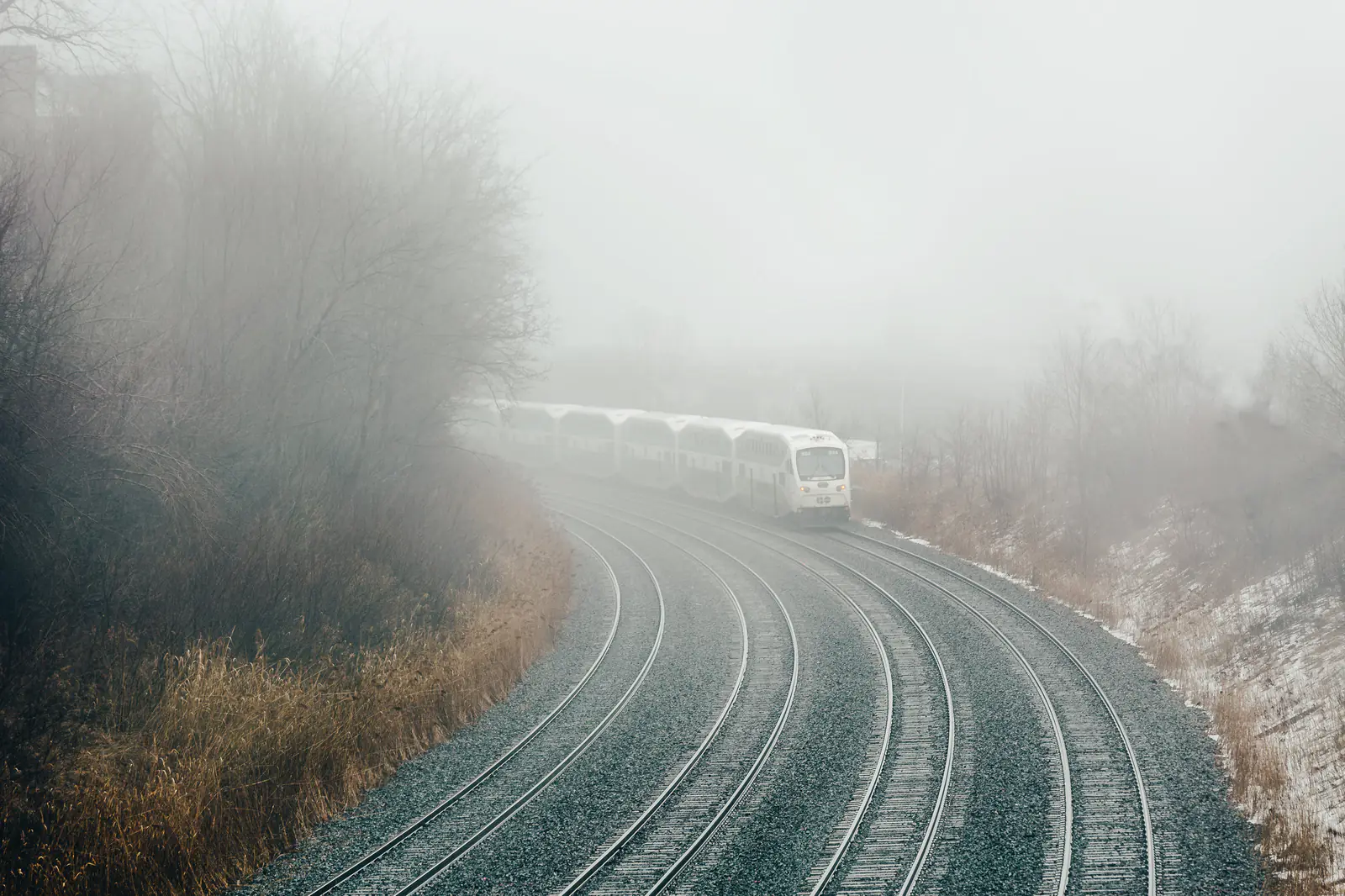 Railway tracks curving into fog