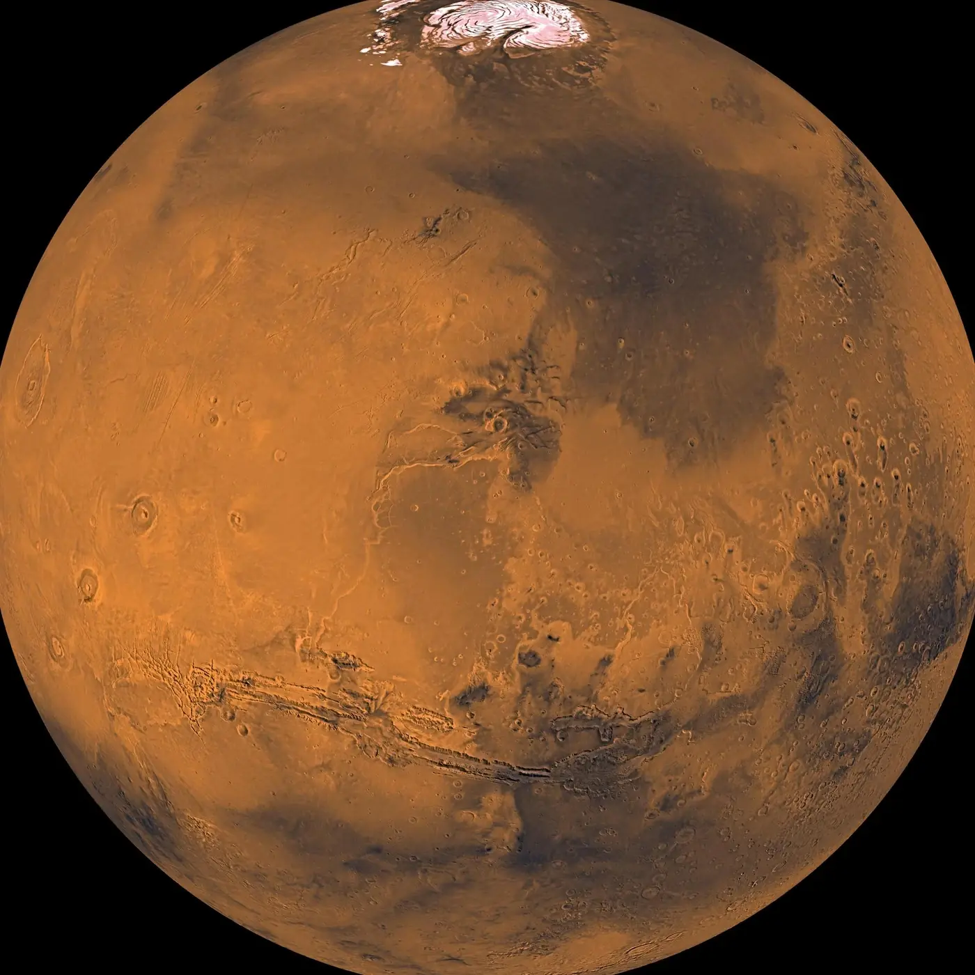 Mars, a rust-orange globe with the long canyon of Valles Marineris, from a Viking Orbiter mosaic