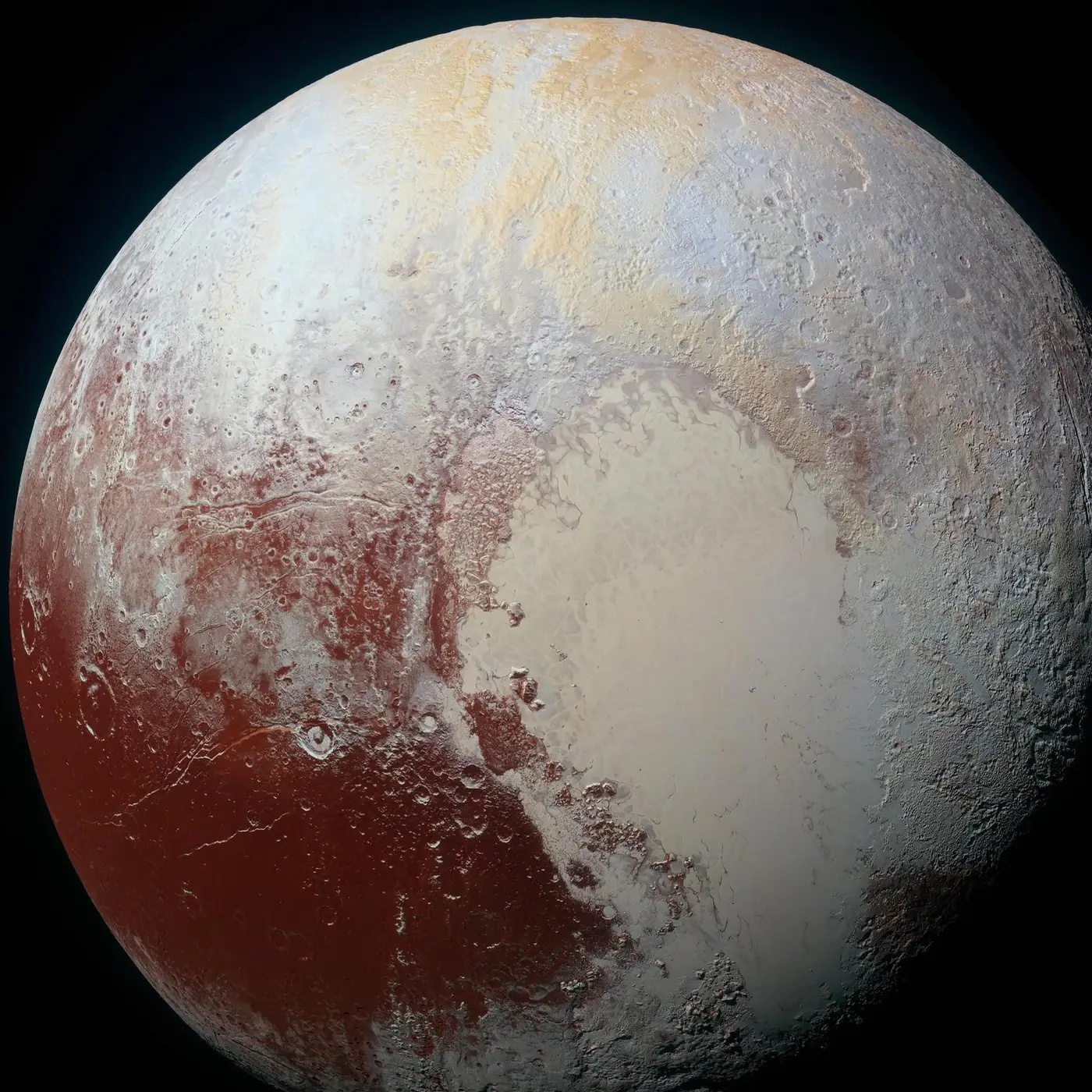 Pluto in enhanced colour, with its pale heart-shaped plain, from New Horizons