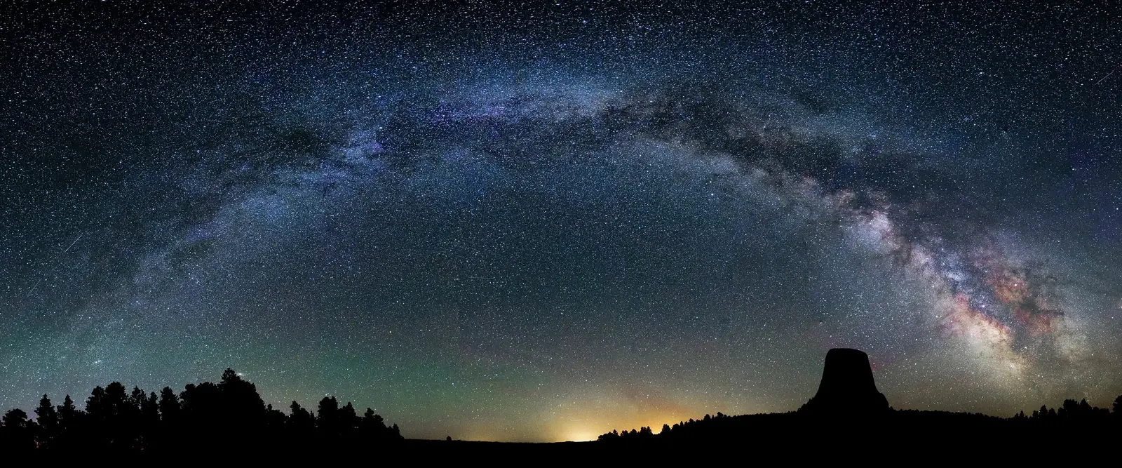 The Milky Way arching across the sky over Devils Tower