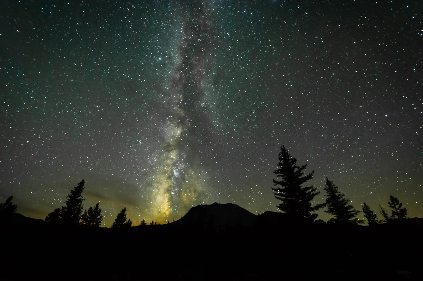 The Milky Way rising over Lassen Peak and a snowy lake
