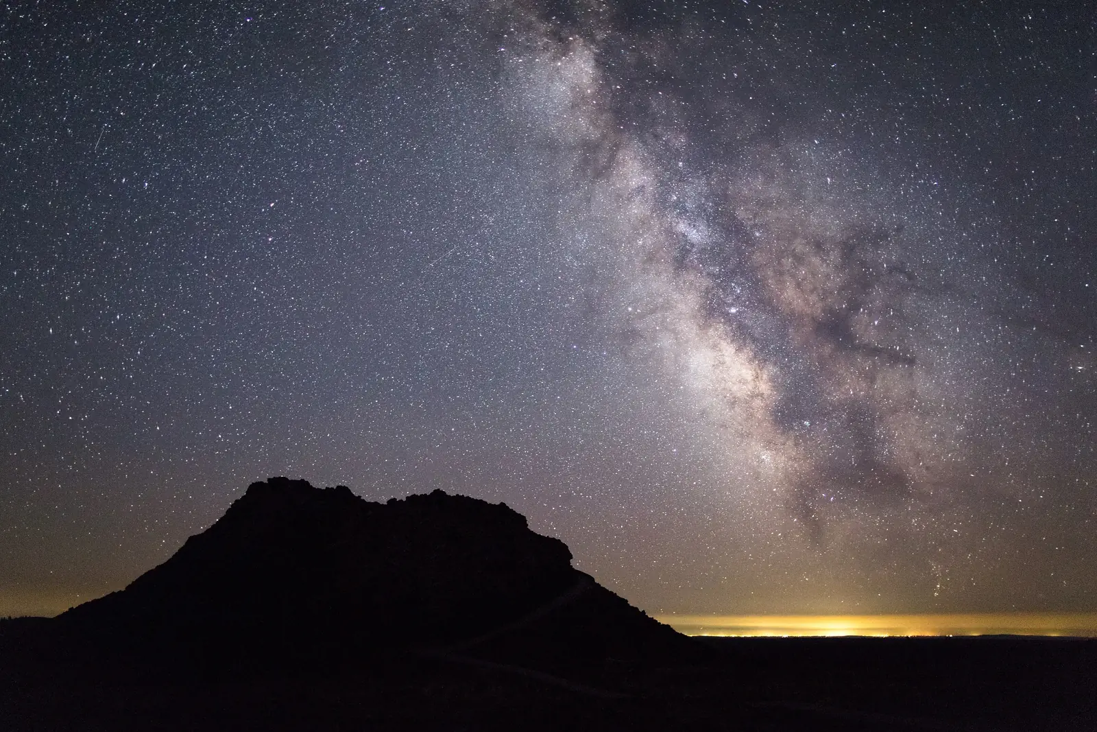 The Milky Way above a dark volcanic spatter cone