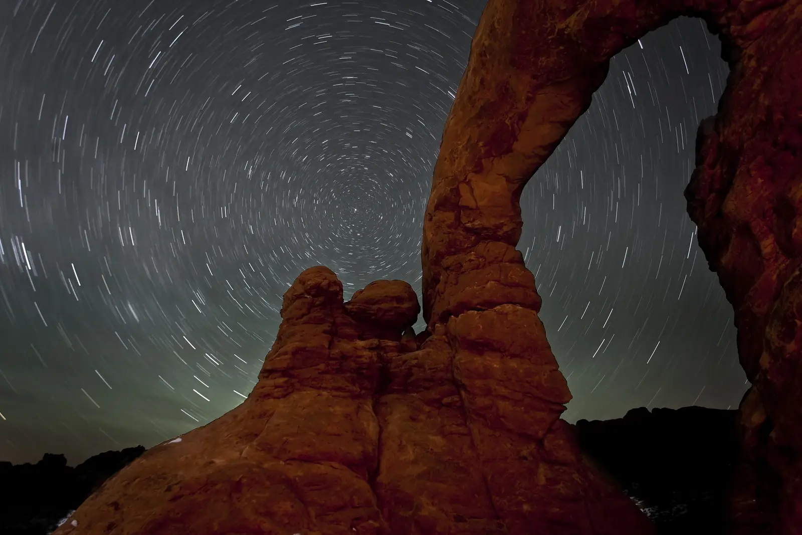 Star trails circling the pole behind Turret Arch