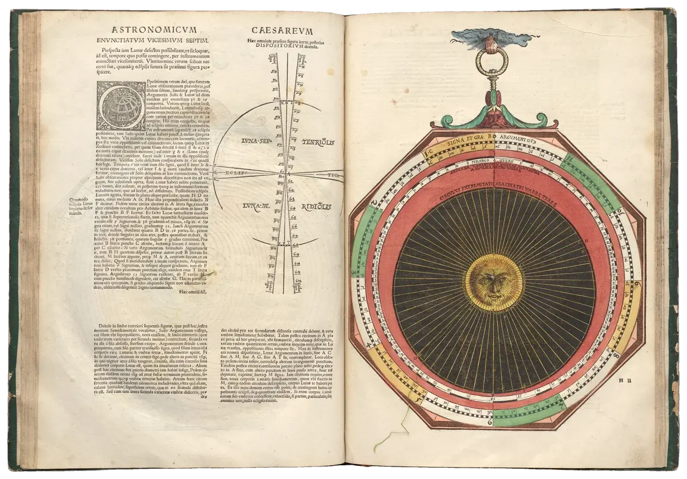 Open 1540 astronomy book with a hand-coloured paper volvelle