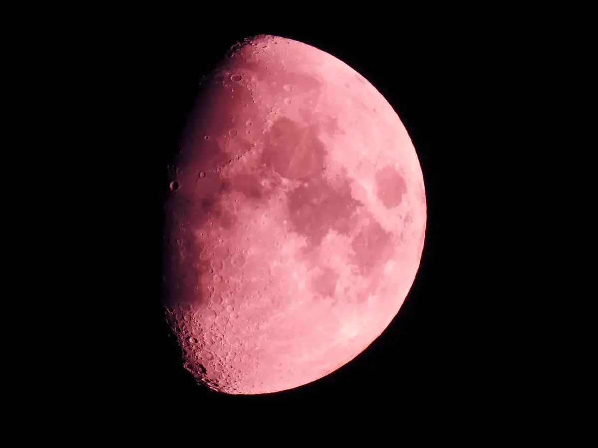 A waxing Moon tinted pink by the atmosphere (Gemini and Leo compatibility)