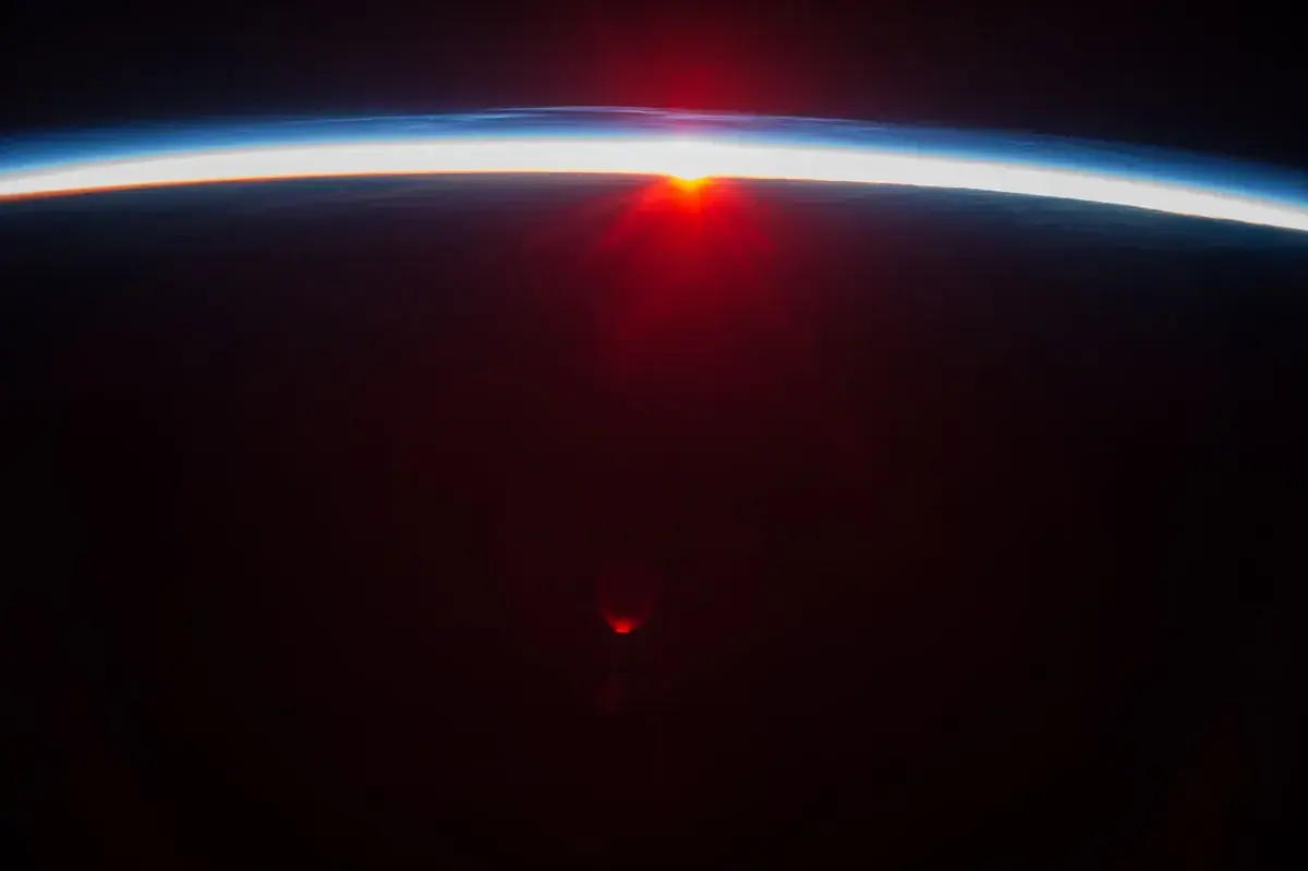 Sunrise breaking along the thin blue line of the Earth's atmosphere