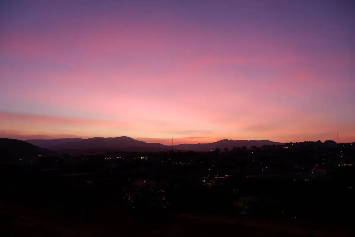 A magenta dusk over dark hills (Leo and Aquarius compatibility)