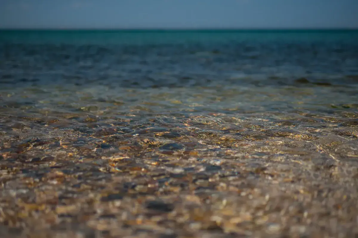 Clear shallow water over a bed of sunlit pebbles (Virgo and Pisces compatibility)