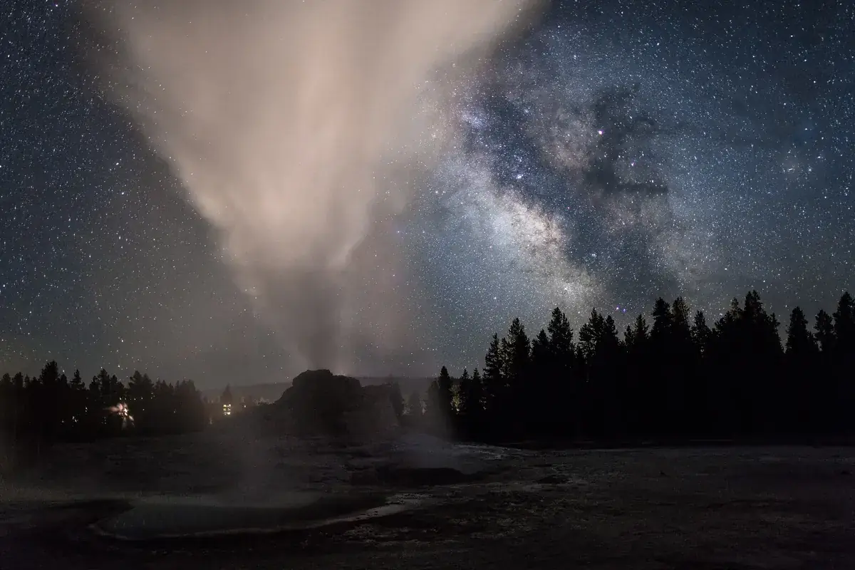 A plume of geyser steam rising into the Milky Way