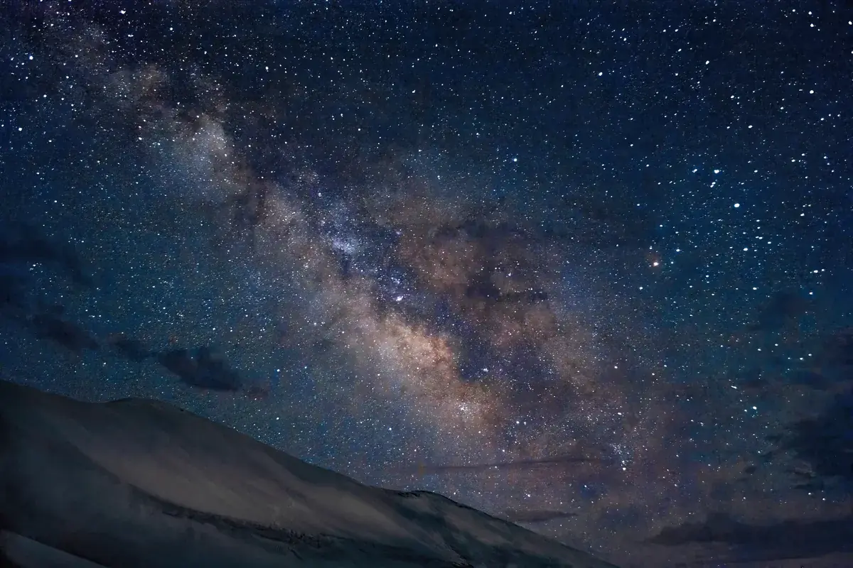 The Milky Way over the sweep of a sand-dune ridge