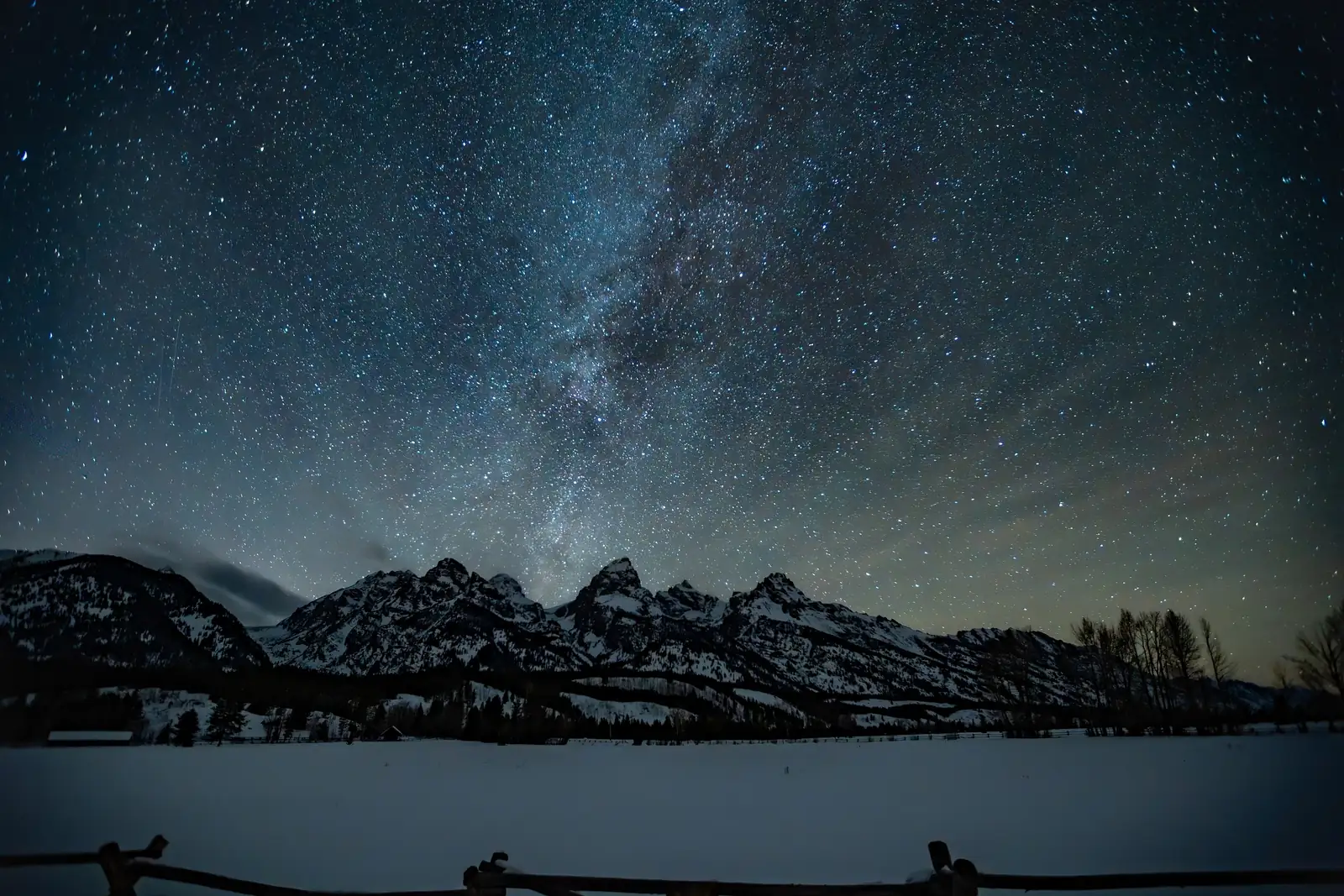 A sky full of stars over the snowy Teton peaks