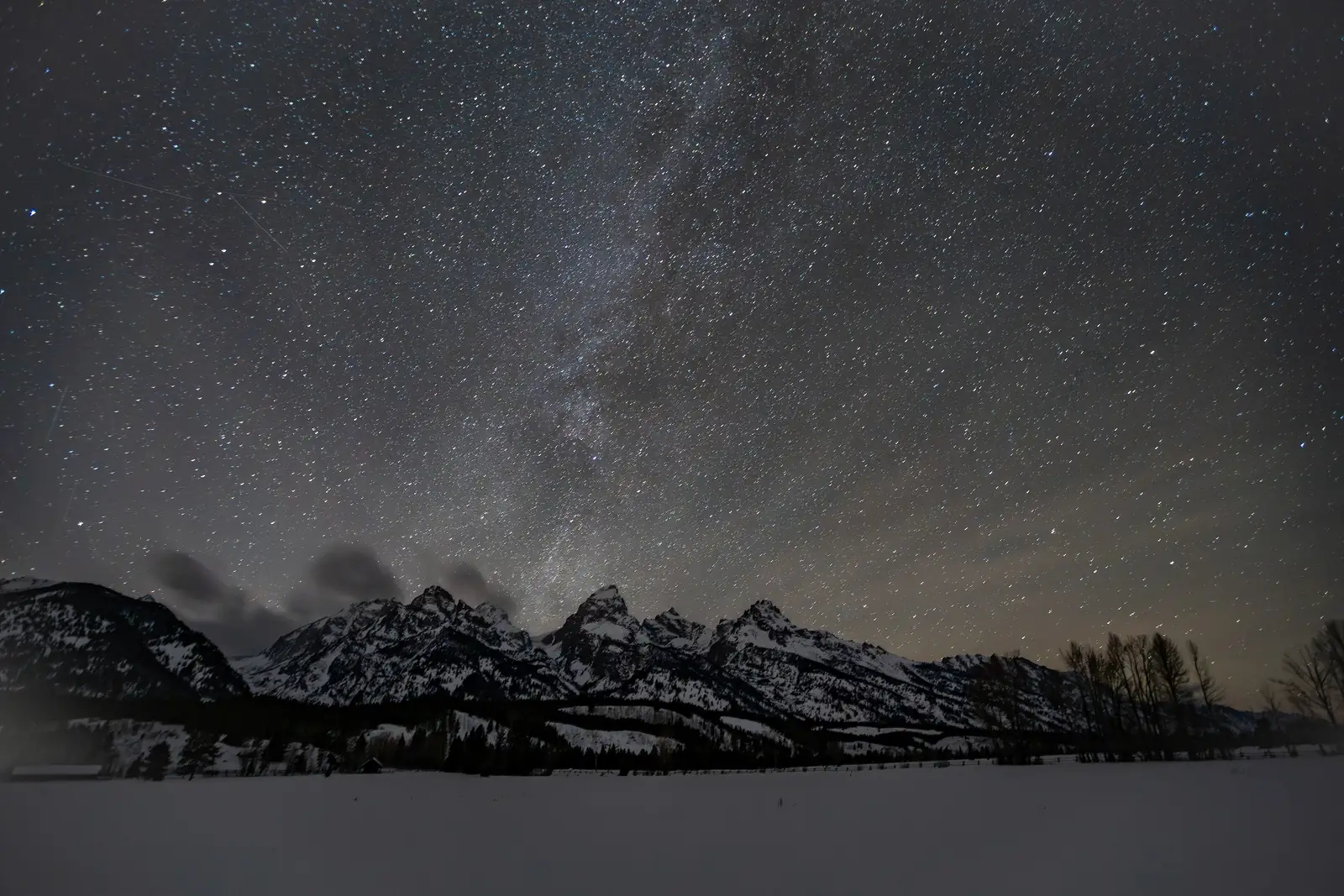 The stars over the snow-covered Teton Range on a winter night